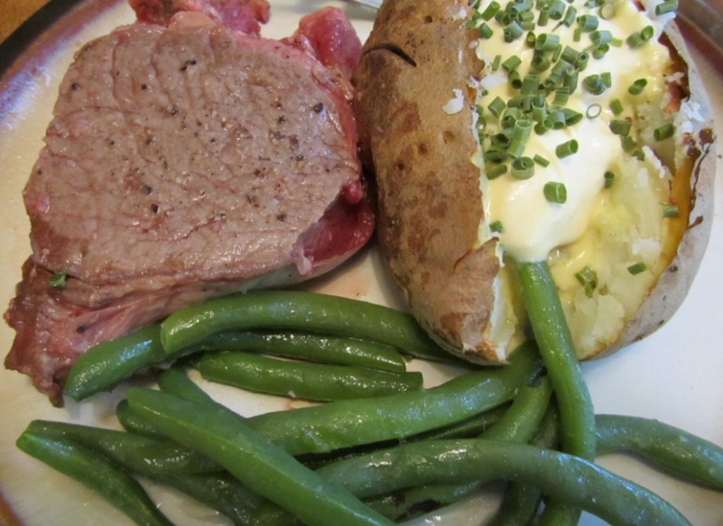 Grassfed ribeye steak green beans and baked potato