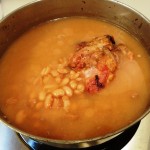 Pot of pinto beans cooked with ham hock